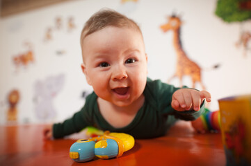 Portrait view of happy cute smiling baby boy. Joy and happiness concept. Love and family emotion
