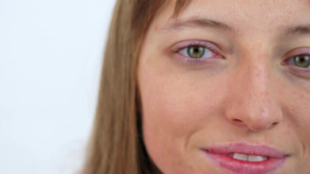 Close up on green woman eye. Gorl opening eye and smiling. Pull out slow motion shot