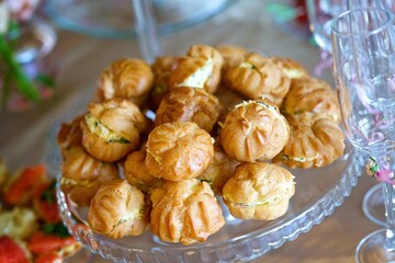 Eclairs with delicious cream on a glass dish