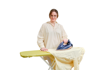 A happy woman irons things with a dark blue iron in a home living room, isolated on a white background