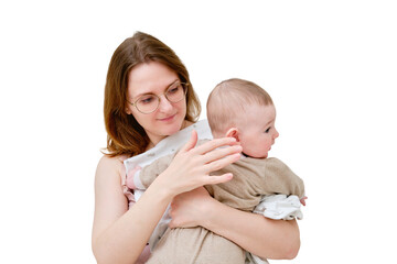 A mother woman holds an infant baby to regurgitate excess air after breastfeeding, isolated on a white background. Mom with a child boy holds vertically after feeding. Kid aged six months