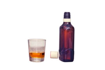 Glass with alcohol and bottle of whiskey, isolated on a white background