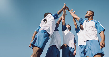 Soccer, team high five and men celebrate winning at sports competition or game with teamwork on...