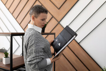 woman businessman examines documents leather folders in the office