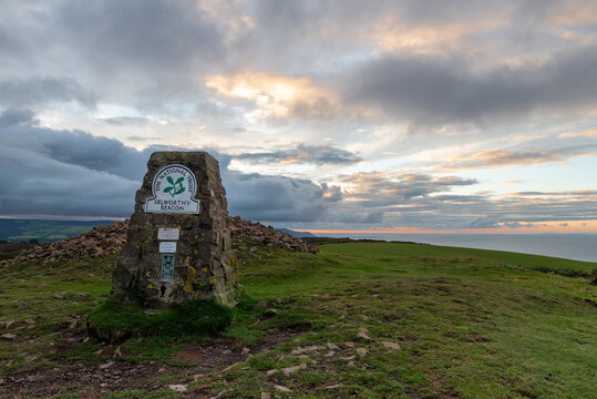 Trig point at Selworthy Beacon on North Hill, Exmoor at sunset
