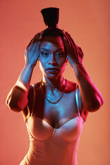 Portrait, hands and hair with a model black woman in studio on a neon background for beauty....
