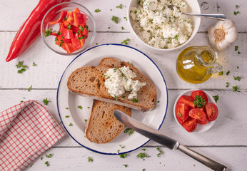 Feta cheese salad with olive oil and herbs served with roasted sourdough bread and vegetables on...
