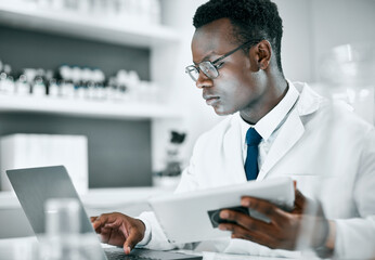 Science, research and black man with tablet and laptop for medical report, analytics and test...