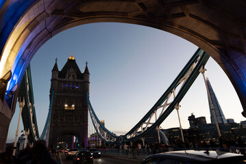 Fototapeta na wymiar Famous Tower Bridge in London, UK, during beautiful evening with colorful lights. Contours of Bridge over the Thames. Landmark and attraction. 