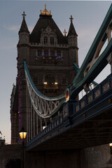 Fototapeta na wymiar Tower Bridge by night with contours of building. London bridge with lantern in England. Vertical.