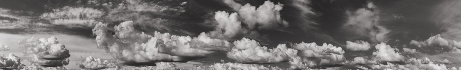 Panorama Of Cloudy Sky. Natural Day Cloudy Sky Abstract Background. Panorama Panoramic View. Backdrop. Copy Space. Black And White Colors.