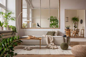 Open space interior with modular sofa, wooden coffee table, big window, patterned pillows, braided...