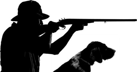 A hunter with a gun in his hands in hunting clothes in the autumn forest in search of a trophy. A man stands with weapons and hunting dogs tracking down the game.