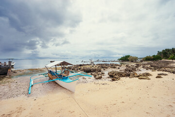 Fototapeta na wymiar Beach with traditional fishing boat. Travel by Philippines.