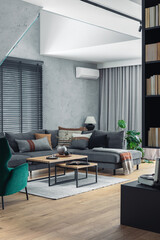 Stylish composition of living room interior with corner grey sofa,  design furniture and minimalist personal accessories. Book shelf. Modern home decor. Template.