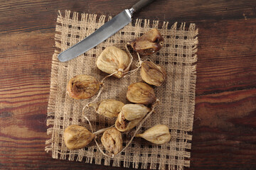 Naturally sweet dried figs in the sun. Dried figs on the wooden table