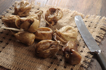 Naturally sweet dried figs in the sun. Dried figs on the wooden table