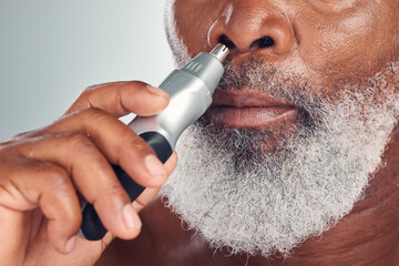 Black man, grooming and nose hair removal with an electric trimmer for shave, beauty and skin care....