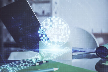 Double exposure of blockchain and crypto economy theme hologram and table with computer background. Concept of bitcoin cryptocurrency.