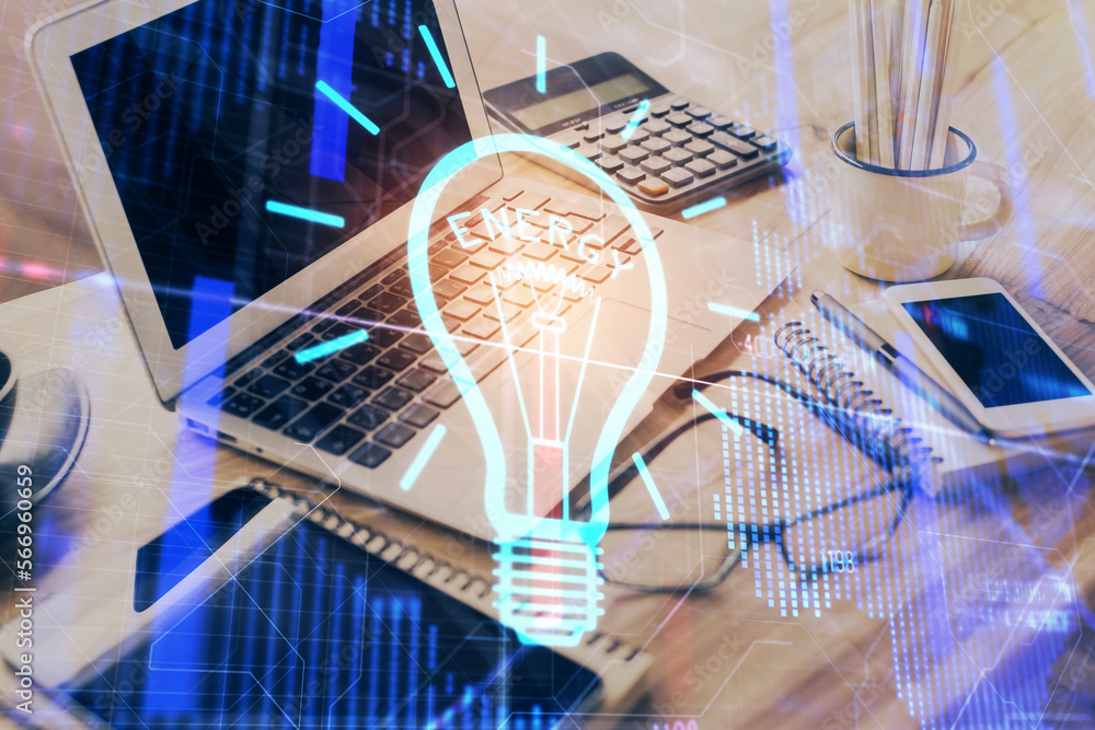 Poster Computer on desktop in office with bulb icon hologram. Double exposure. Concept of idea.