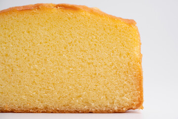 Homemade butter cake slice close up on isolated white background