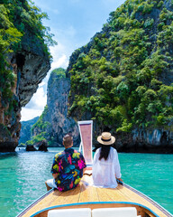 Longtail boat in Krabi Thailand, couple man, and woman on a trip at the tropical island 4 Island