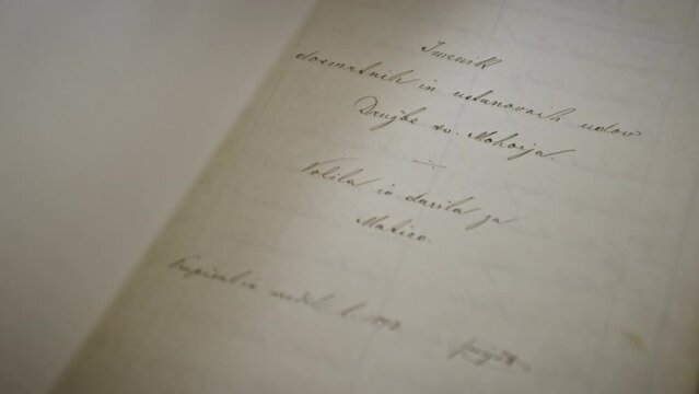 Close up of an book, man's hand flips the page, hand writen text.