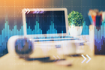 Financial market graph hologram and personal computer on background. Multi exposure. Concept of forex.