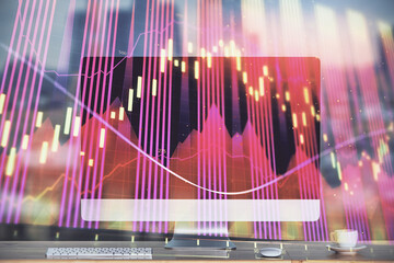 Obraz premium Financial market graph hologram and personal computer on background. Double exposure. Concept of forex.