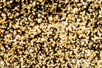 Golden shiny background. Abstract vibrant color glowing white spots texture for graphic design. Bright yellow defocused glitter texture. Festive background. Party texture.	