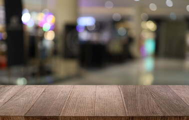 Empty wooden table in front of abstract blurred background of coffee shop . can be used for display or montage your products.Mock up for display of product