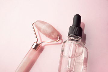 Quartz roller and liquid face serum in a glass bottles with a dropper