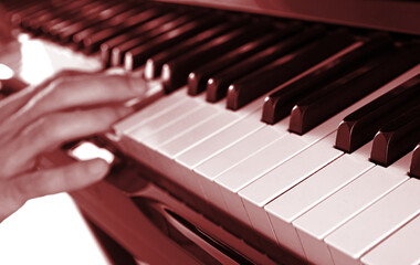 Hands playing music on piano