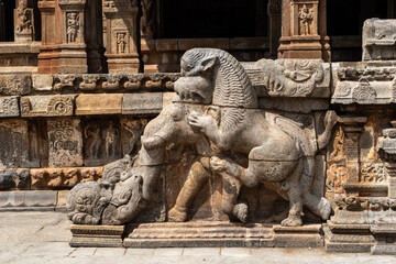 Beautiful stone sculpture of a lion eating an elephant at the entrance to the ancient Airavatesvara temple in Darasuram.