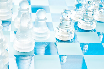 glass chess pieces and chessboard