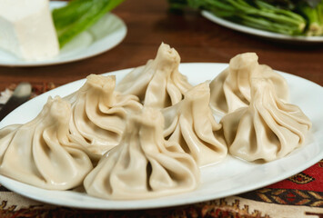 Traditional Georgian khinkali, selective focus.  Georgian cuisine. Meat khinkali, delicious dumplings on a plate. Tasty eating concept. . Copy space