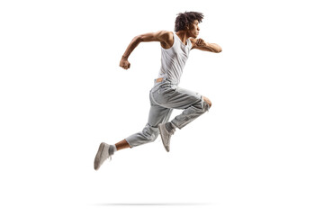 Fototapeta na wymiar Full length profile shot of an african american male dancer jumping