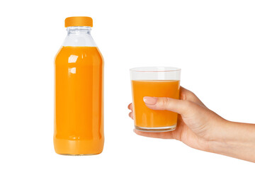 Bottle of fresh orange juice. The hand holds a glass of juice. Isolated on white background.