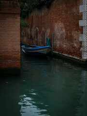 Fototapeta na wymiar small boat at small canal at Venice Italy
