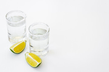 Tequila with lime and salt in glasses, top view