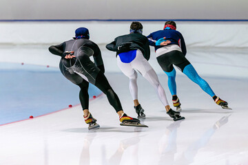 back group of speed skaters warm up in ice skating