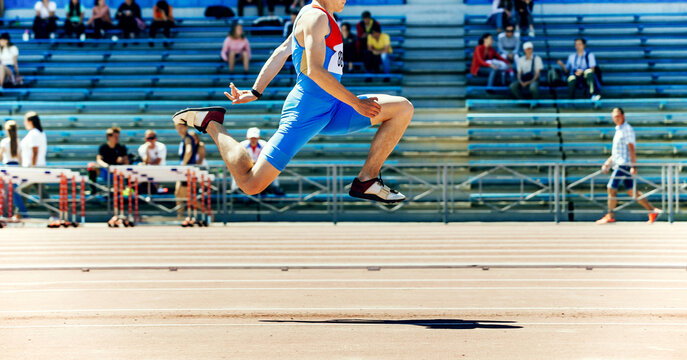 male athlete triple jump track and field competition