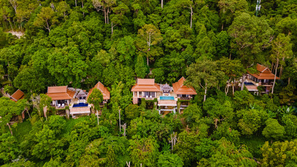 couple of men and woman on a luxury vacation at a pool villa in the jungle rainforest