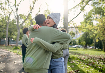 Hug, friends and happy volunteer people outdoor at nature park with care for earth. Woman and man...