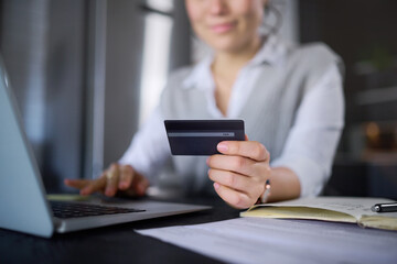 Laptop, online shopping and hands of woman with credit card for digital banking or payment. Ecommerce, fintech and female with computer for buying, paying bills or finance budget in home at night.