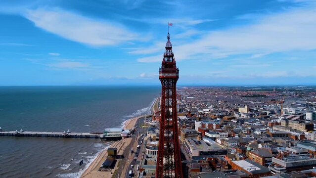 pier overhead view. Birds flying on the Ferris wheel and the pier. Waves crashing on the shore in the blue sea