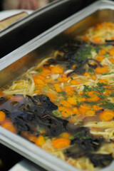 Closeup shot of carrot mushroom soup serve on buffet