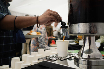 Man hand pouring the cola in dessert corner event