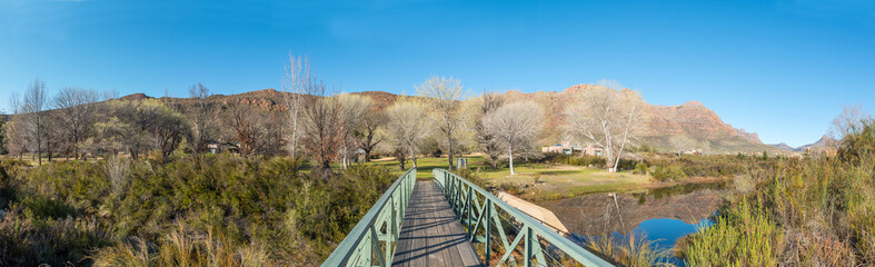 Fototapeta na wymiar Panoramic view of the pedestrian bridge over Krom River