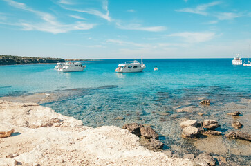 Tourist boats are mooring at Blue lagoon at Akamas peninsula on Cyprus